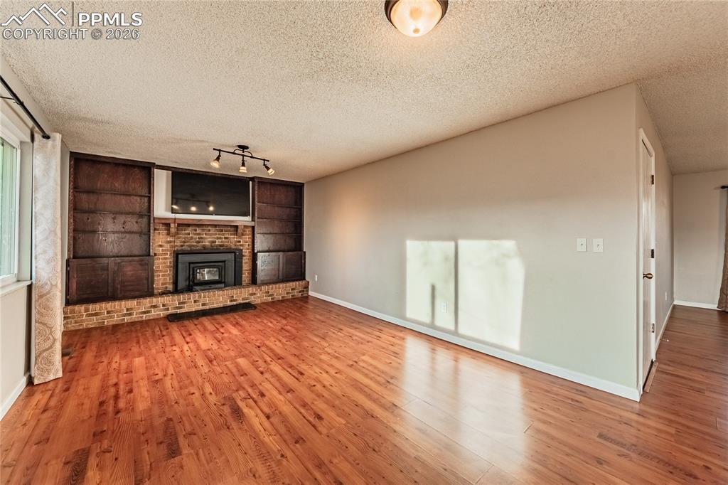 Image 11 of 49: Massive open living room with built in shelves