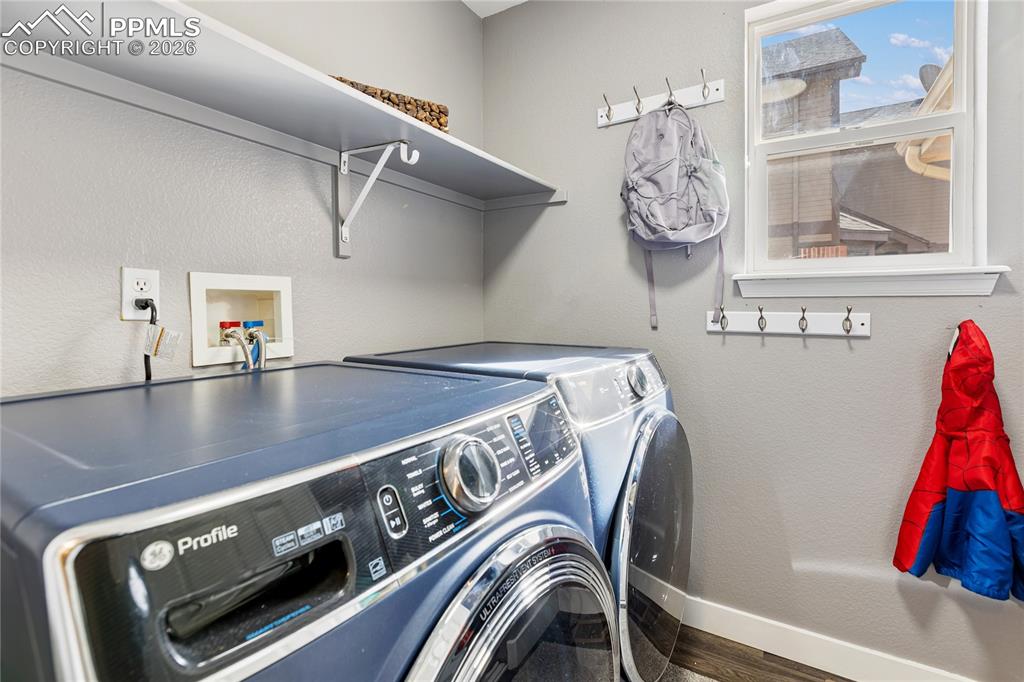 Image 34 of 38: large main level laundry with large wall pantry