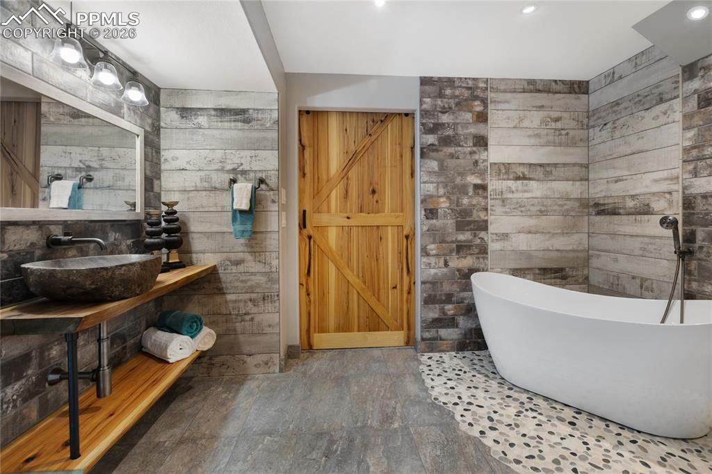 Image 8 of 38: Custom sink and wood counter, plus additional barn door