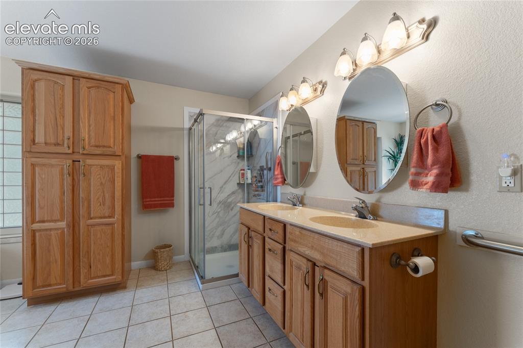 Image 13 of 43: Dual vanity with integrated sinks and a light-toned countertop