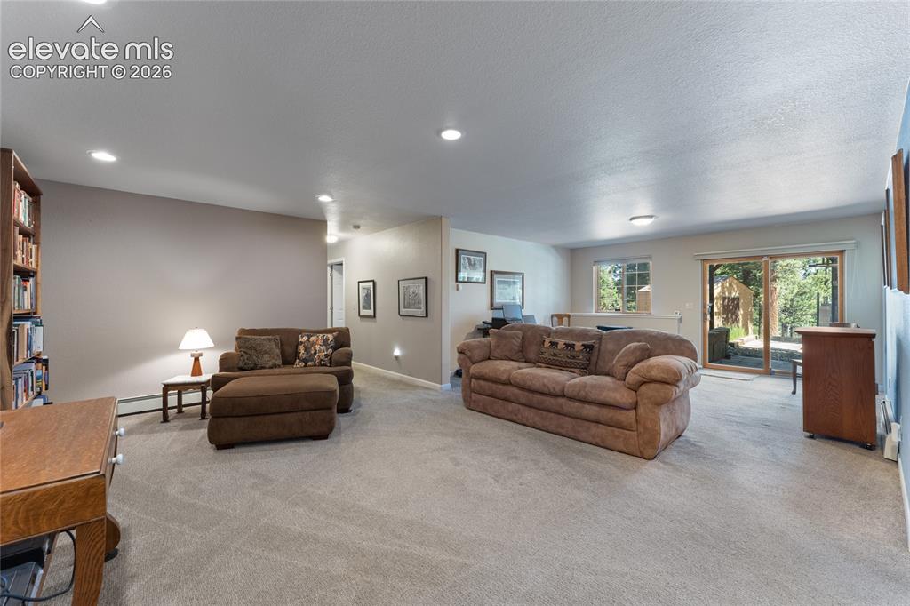 Image 24 of 43: Spacious interior featuring neutral carpet flooring, recessed lighting, and