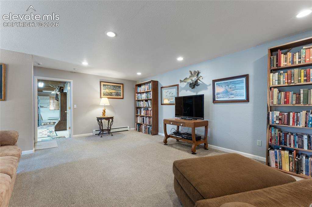 Image 27 of 43: Spacious carpeted room featuring recessed lighting and built-in shelving