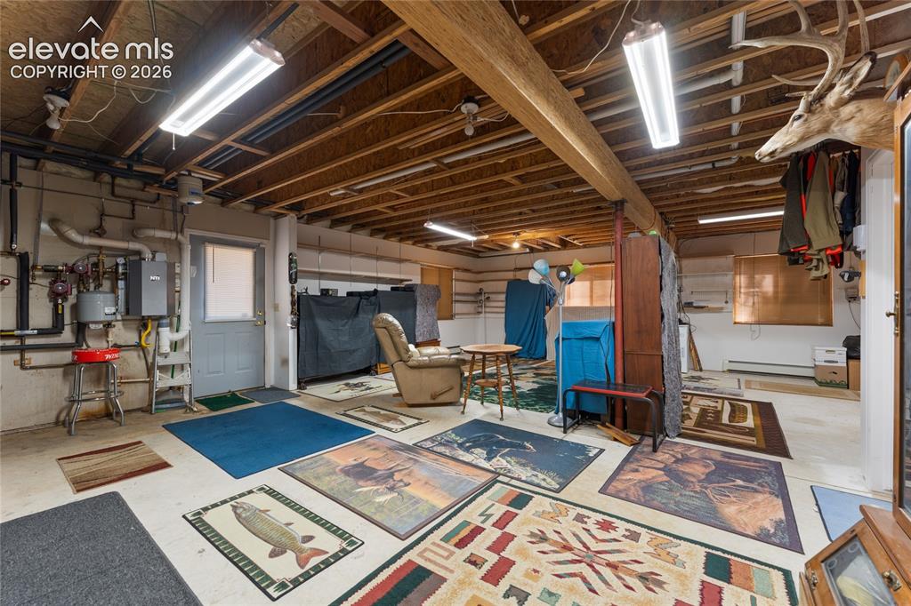 Image 33 of 43: Spacious unfinished basement offering exposed wooden ceiling joists, concre