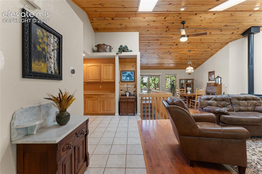 Image 4 of 43: Vaulted wood-paneled ceiling with skylights and a ceiling fan