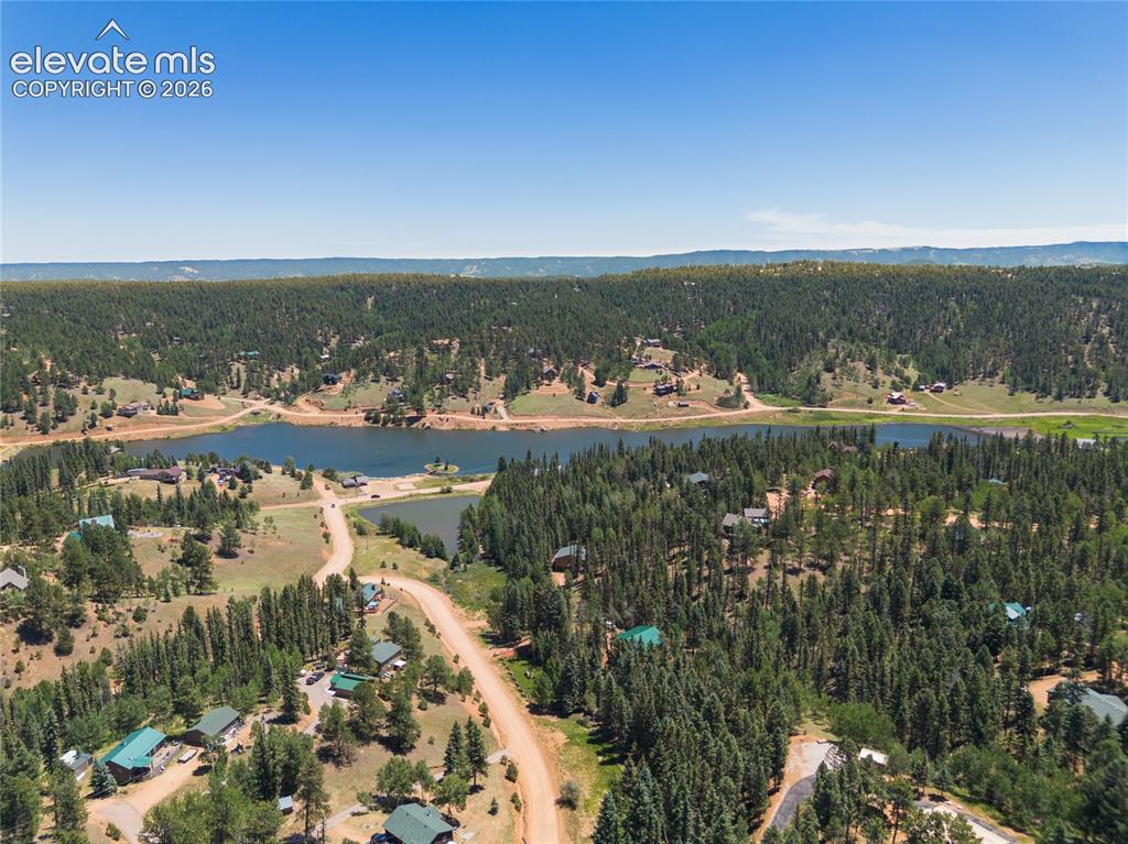 Image 43 of 43: Expansive forested landscape featuring multiple lakes, scattered residences