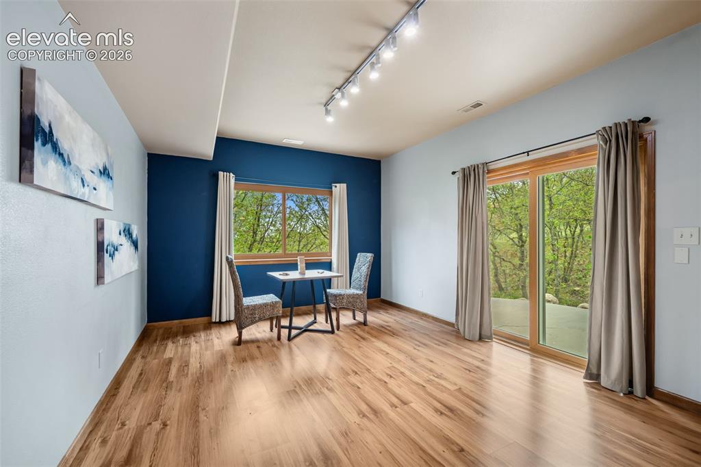 Image 27 of 36: Upper level primary bathroom with double sided fireplace and free standing 