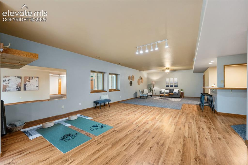 Image 28 of 36: Upper level primary bathroom has a double sink vanity, granite countertops,
