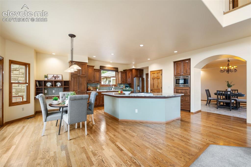 Image 7 of 36: Foyer has hardwood flooring and curved staircase