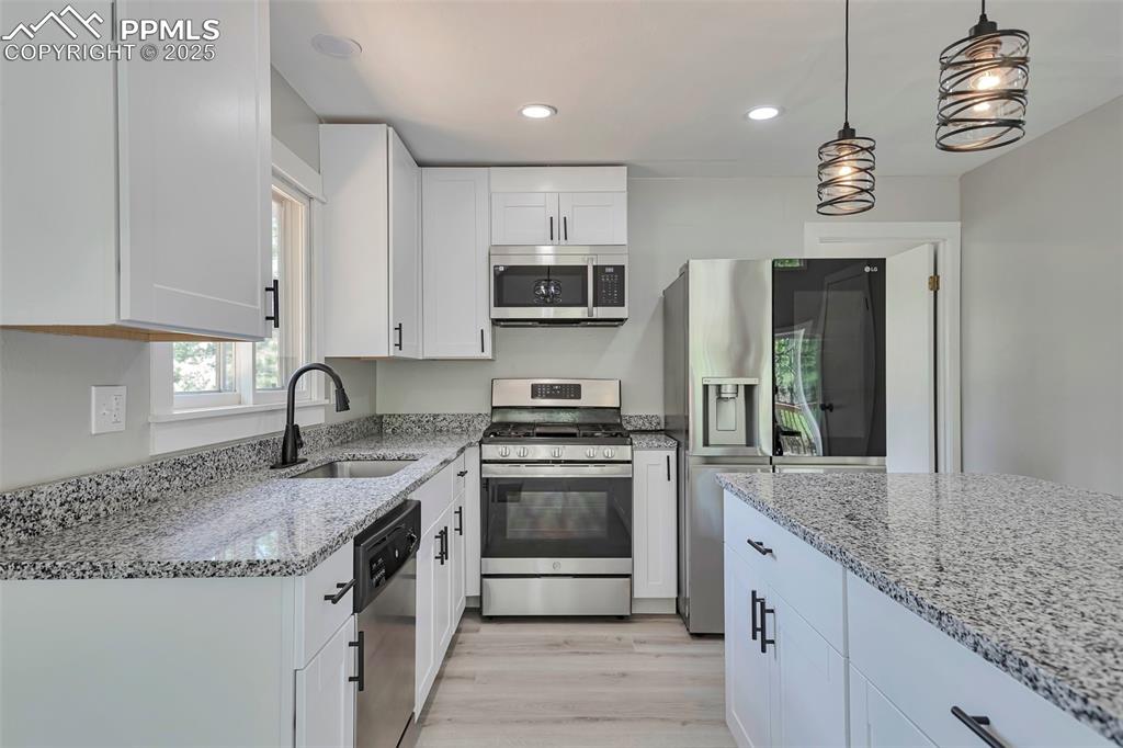 Image 12 of 33: Kitchen featuring kitchen island.