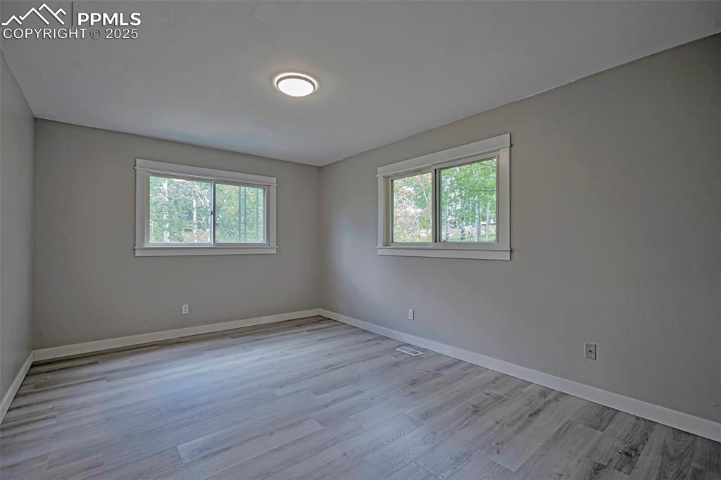 Image 13 of 33: Primary Bedroom with beautiful flooring.