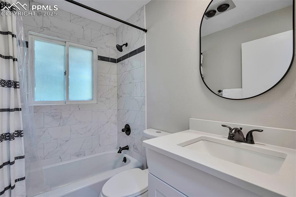 Image 27 of 33: Basement Full bath featuring shower / tub combo and vanity.