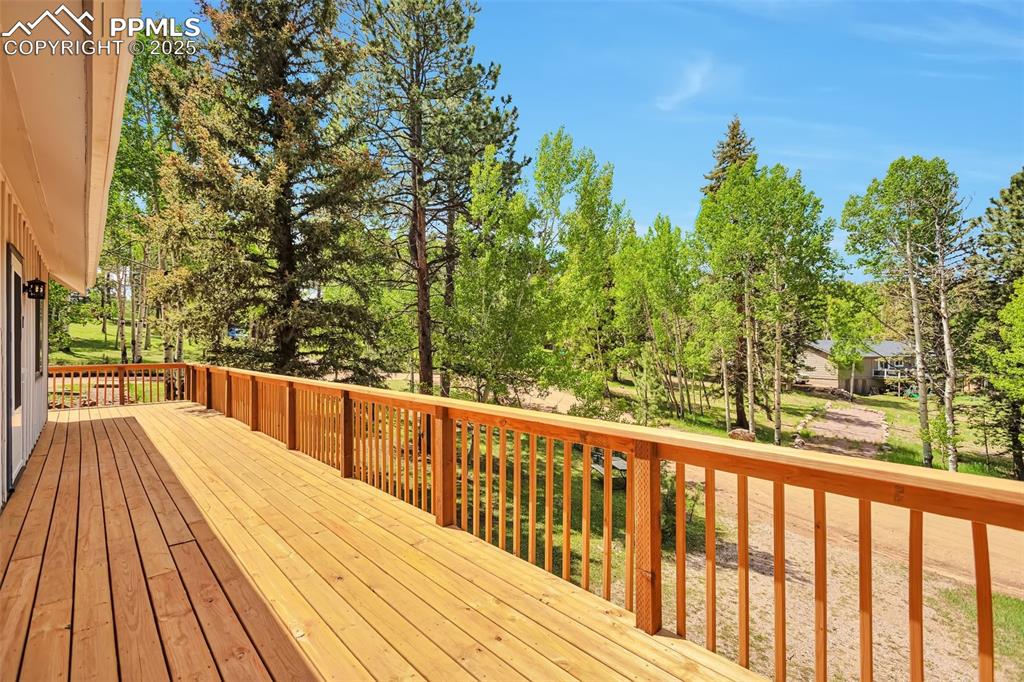 Image 29 of 33: Deck featuring view of scattered trees