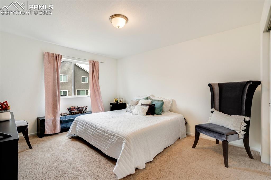 Image 18 of 29: Bedroom featuring light carpet and baseboards