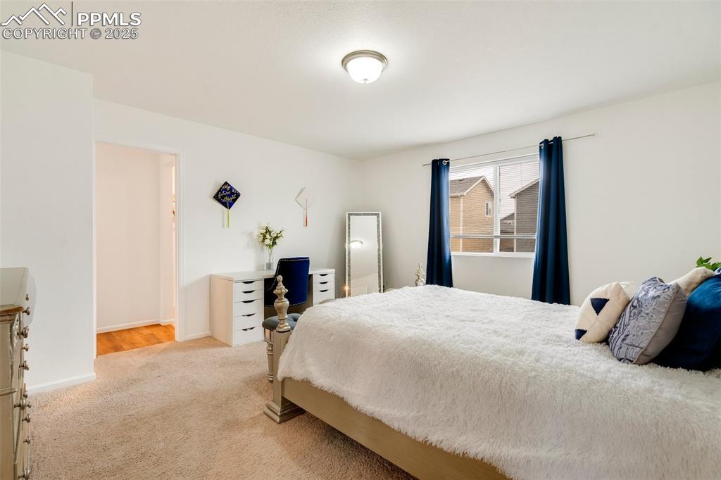 Image 19 of 29: Bedroom with baseboards and carpet flooring
