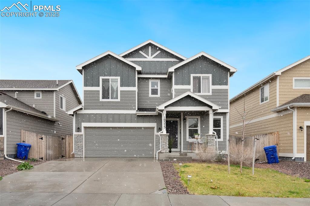Image 2 of 29: Craftsman-style house with concrete driveway, fence, a garage, board and ba