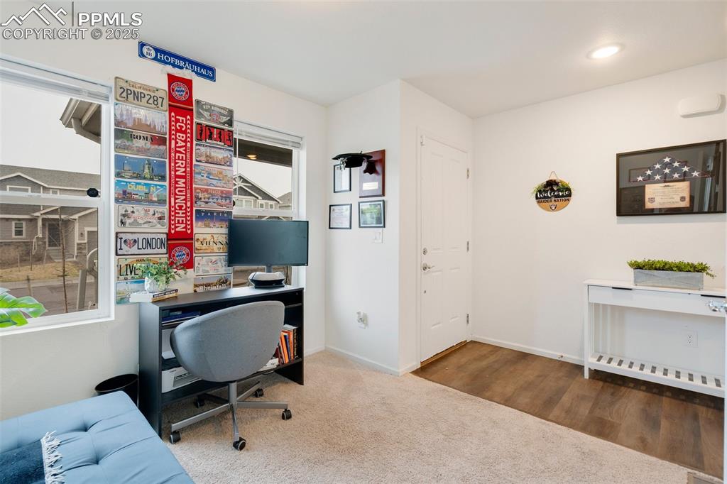 Image 23 of 29: Home office with carpet floors and baseboards