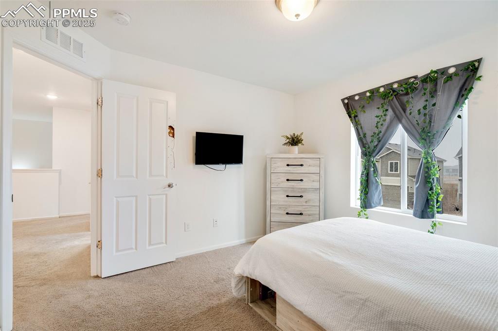Image 25 of 29: Bedroom featuring baseboards, visible vents, and carpet floors