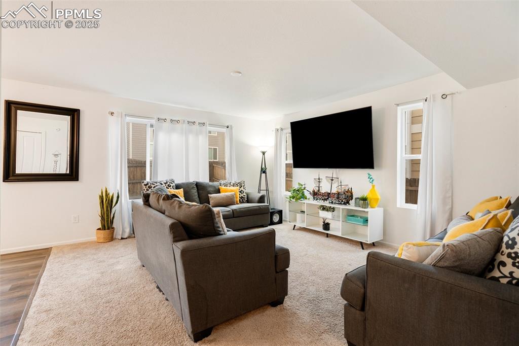 Image 3 of 29: Living room featuring wood finished floors and baseboards