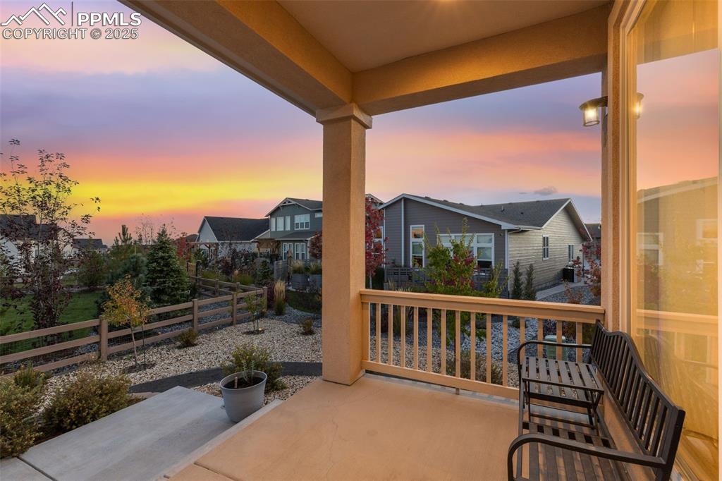 Image 11 of 49: Patio terrace at dusk featuring a residential view and a patio area