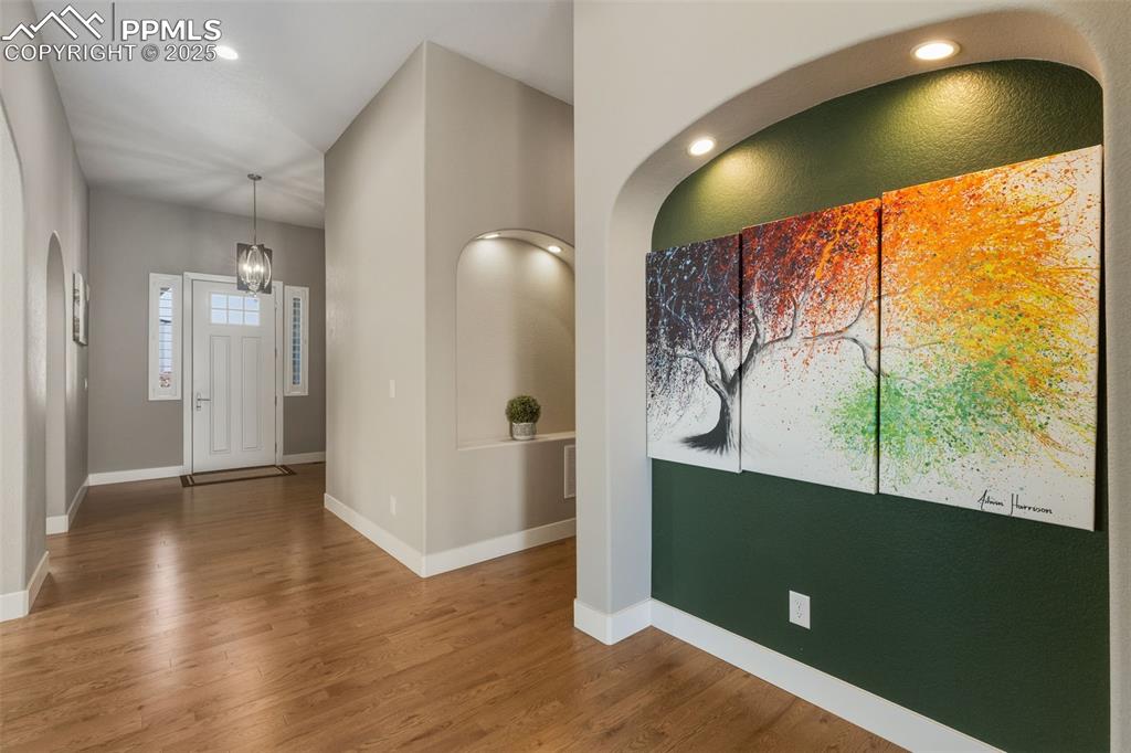 Image 14 of 49: Foyer with recessed lighting and wood finished floors