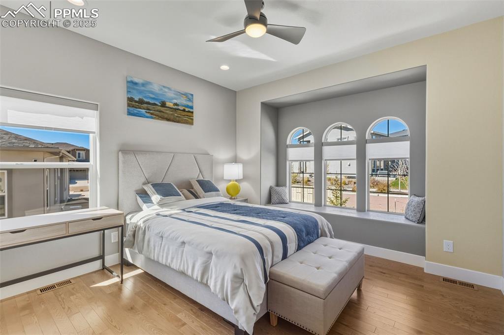 Image 29 of 49: Bedroom with hardwood / wood-style floors, ceiling fan, and recessed lighti