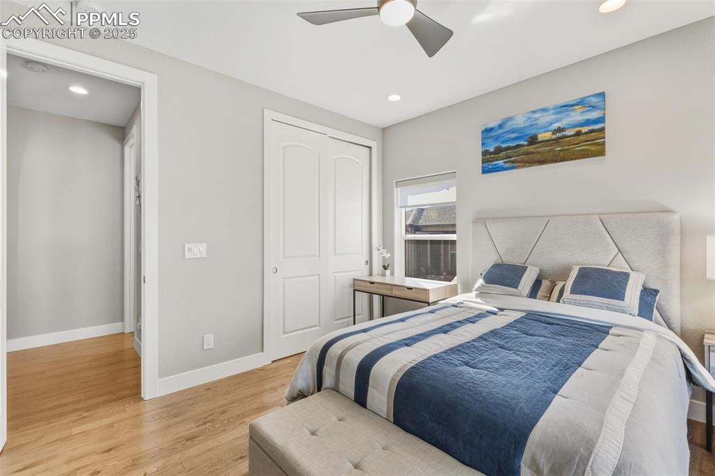 Image 30 of 49: Bedroom with light wood-type flooring, a closet, recessed lighting, and cei