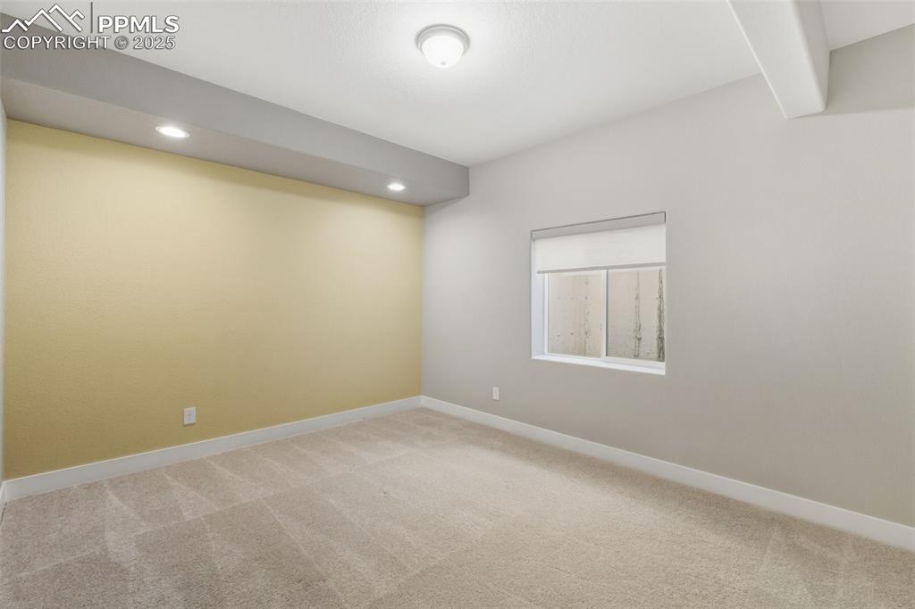 Image 42 of 49: Carpeted empty room with recessed lighting and beam ceiling