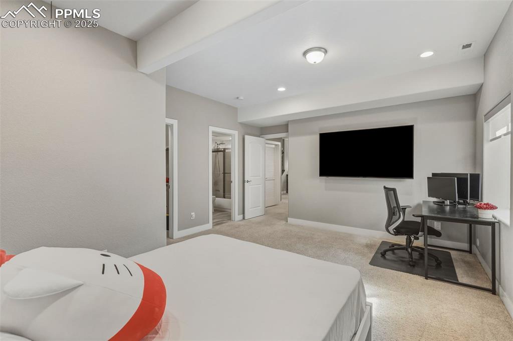 Image 45 of 49: Bedroom featuring light carpet, a desk, ensuite bath, and recessed lighting