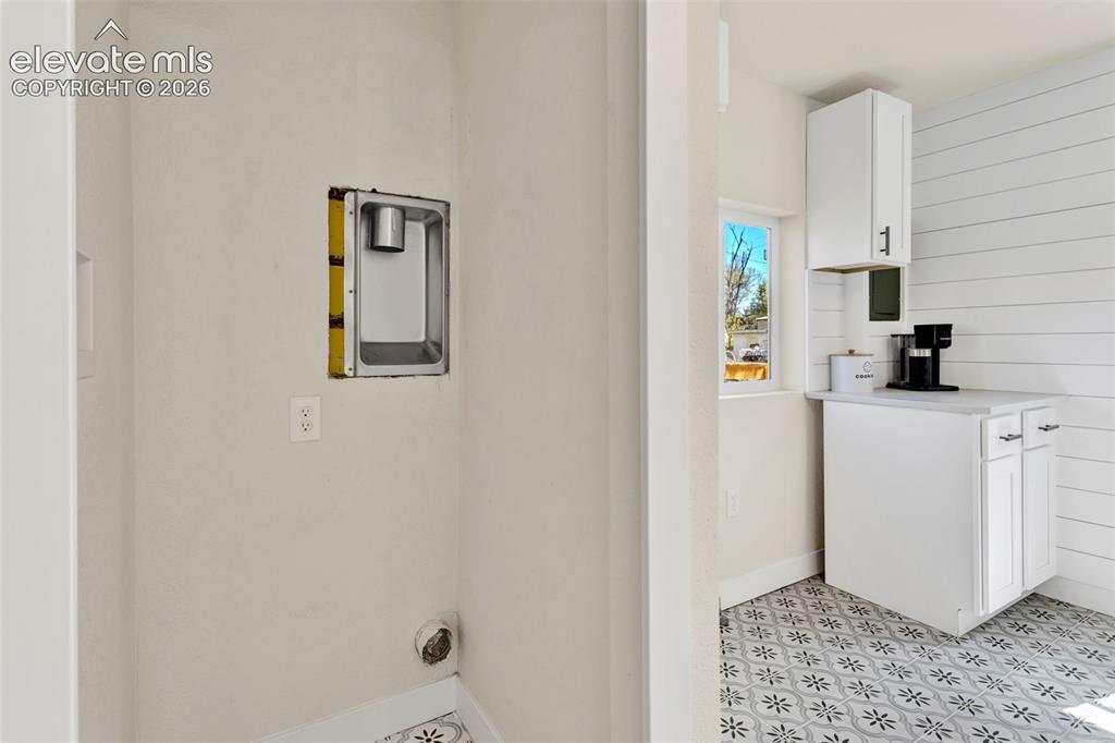 Image 16 of 26: Dedicated laundry area featuring an electrical outlet and dryer vent