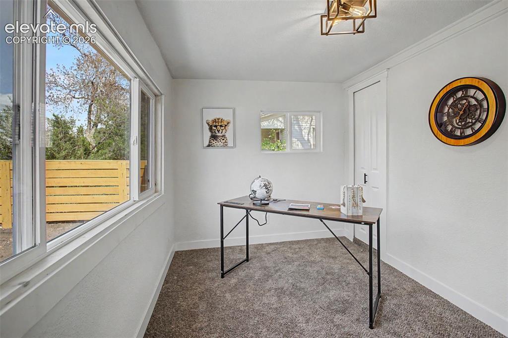Image 25 of 26: Bright room featuring extensive windows, a contemporary ceiling light fixtu