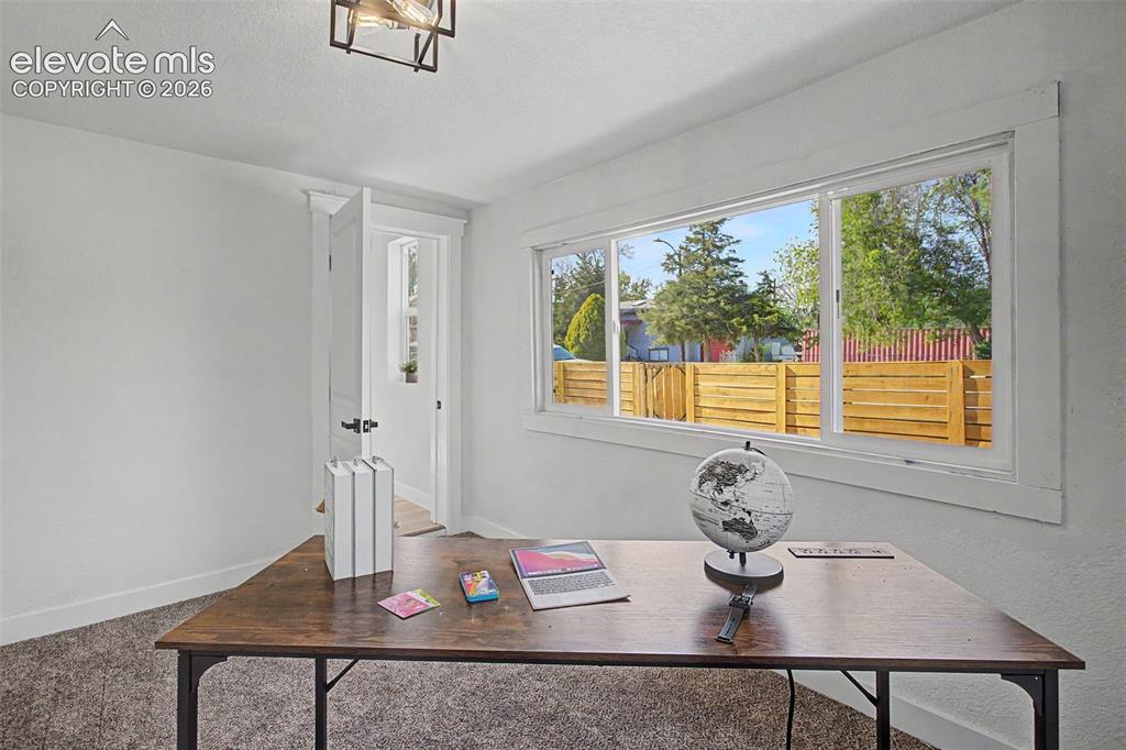Image 26 of 26: Bright room featuring a large horizontal window, white trim, light-toned wa