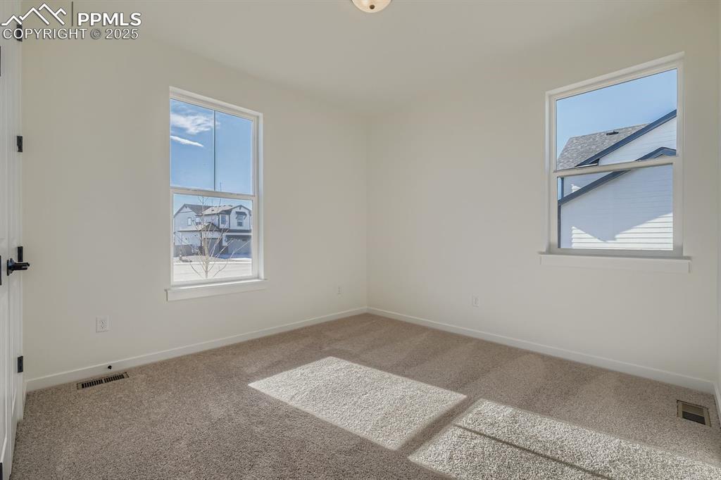 Image 16 of 27: Carpeted spare room with baseboards