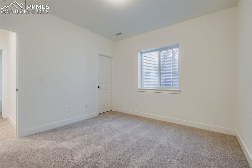Image 19 of 27: Spare room featuring light colored carpet and baseboards