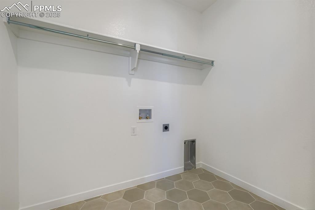 Image 24 of 27: Washroom with hookup for an electric dryer, hookup for a washing machine, a