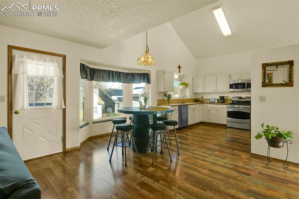 Image 10 of 38: Great Room Dining and Kitchen area