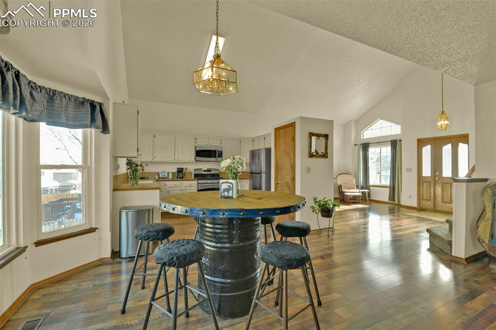 Image 11 of 38: View from family room into kitchen, living room and entry.