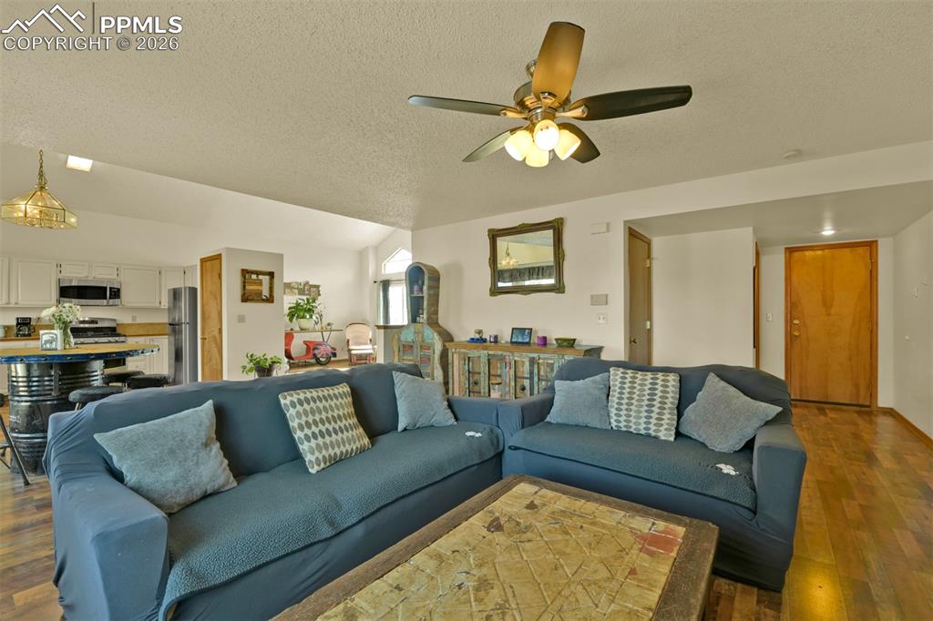 Image 14 of 38: Spacious family room. Powder room, Laundry and entry to the garage are to t