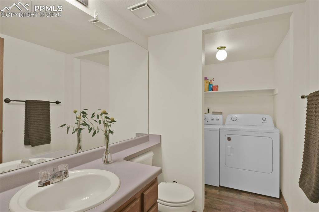 Image 15 of 38: Main level 1/2 bathroom and laundry area.