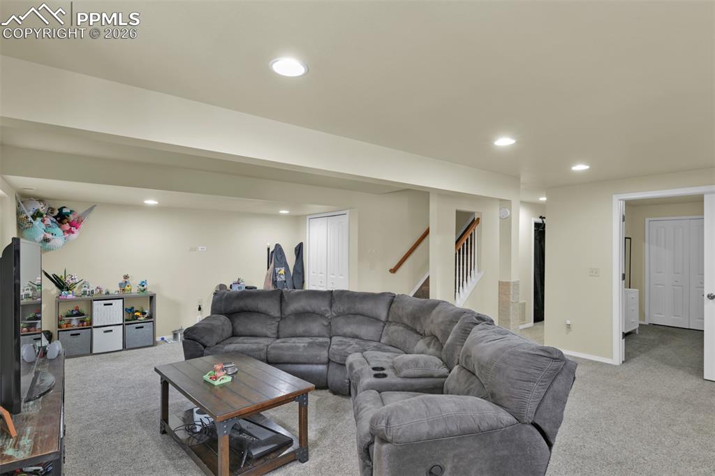 Image 27 of 38: Basement Receation area. Bedroom to the right. Down the Hall to the Full Ba