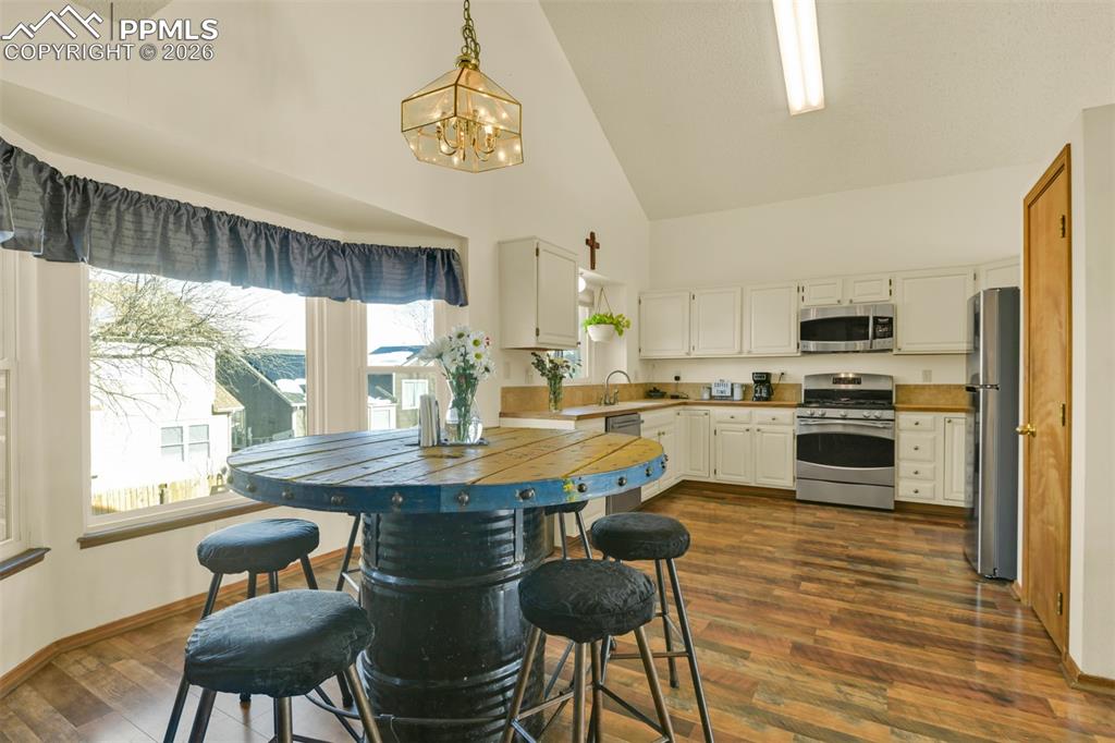 Image 6 of 38: Kitchen with eat-in dining area.