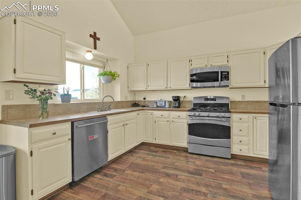 Image 7 of 38: Large kitchen with lots of cabinets and prep space.