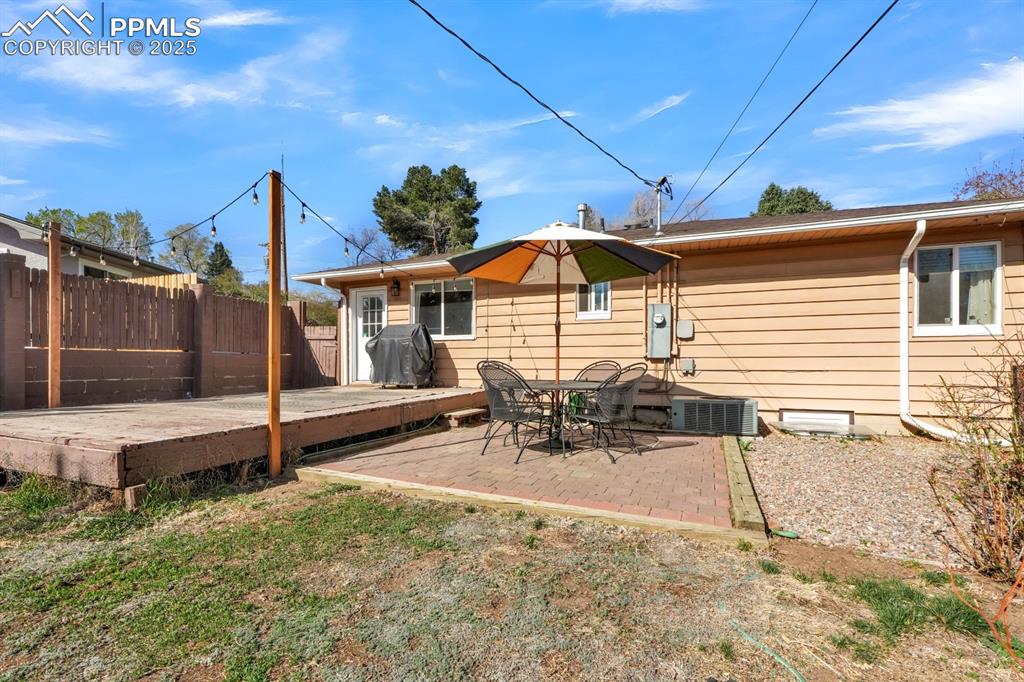 Image 24 of 33: Rear view of property with a patio and a wooden deck