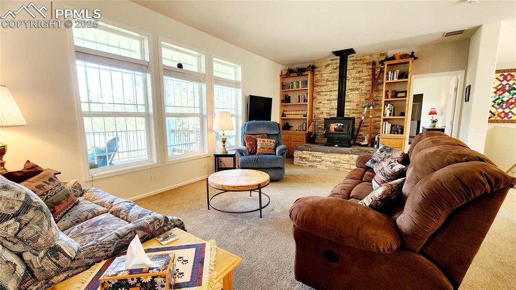 Image 14 of 50: Living room couch, loveseat and lazy boy can stay with the home!