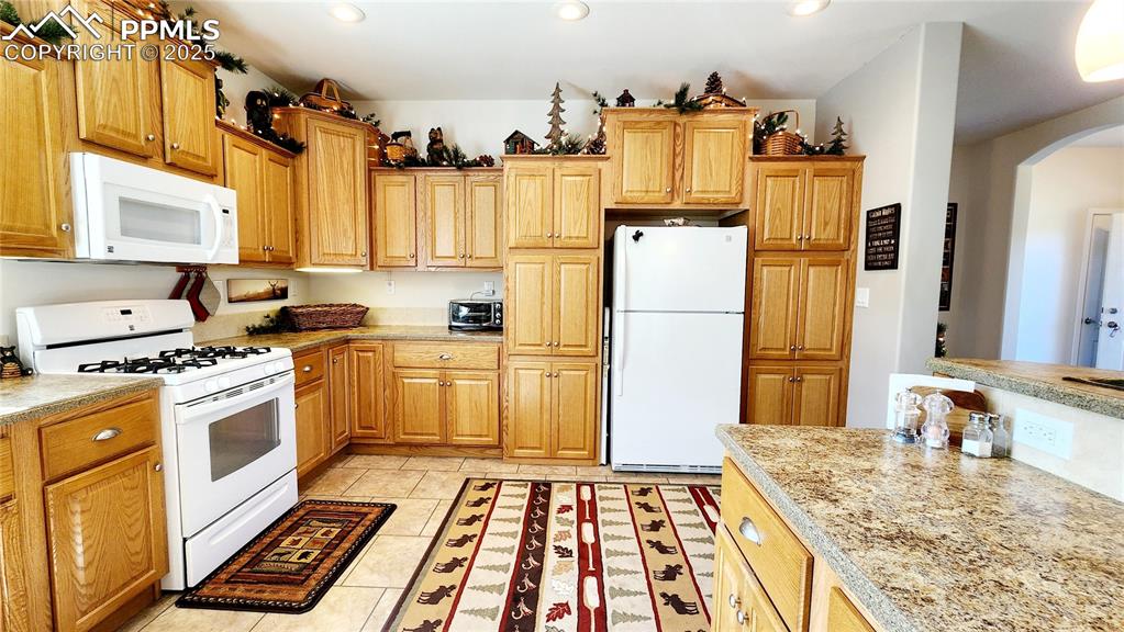 Image 16 of 50: Plentiful storage in this large open, beautiful kitchen