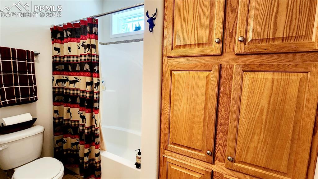 Image 34 of 50: Beautiful 2nd bathroom with tub and shower and lots of amazing storage spac