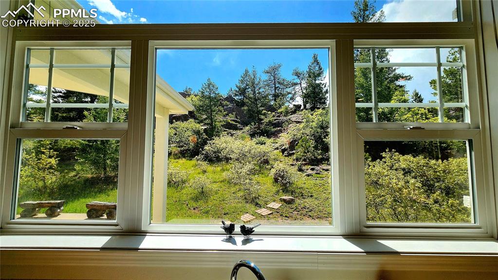 Image 8 of 50: front view of home, driveway and property