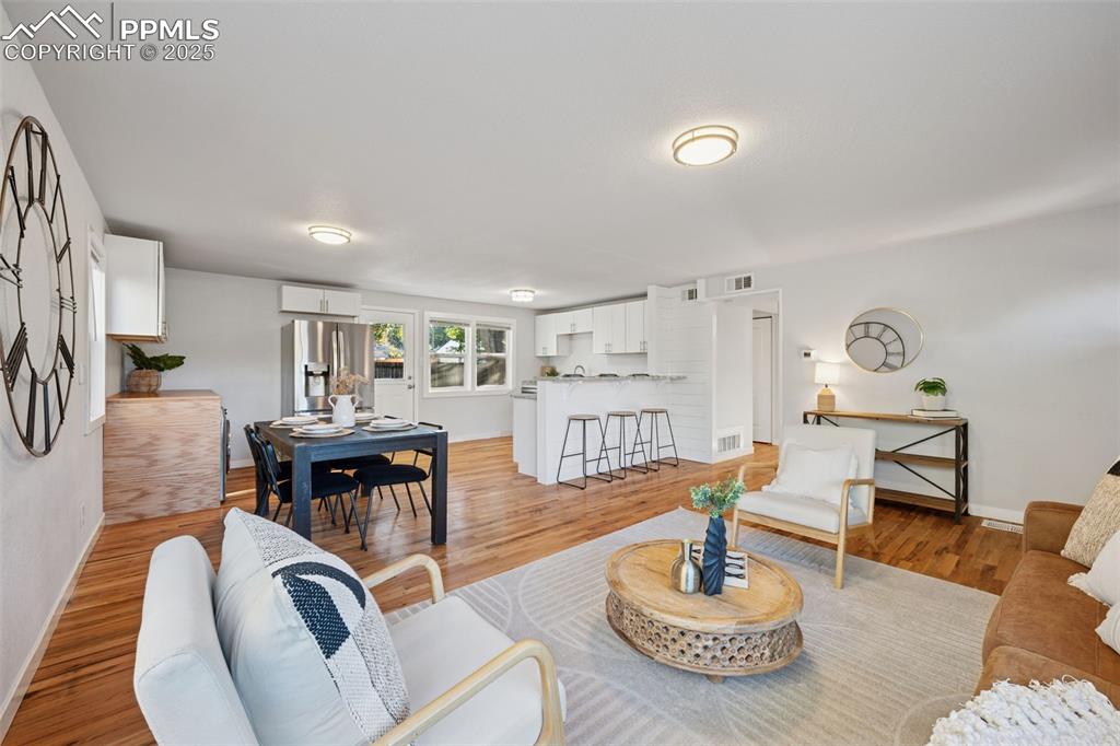 Image 11 of 20: Living room with light wood-style flooring