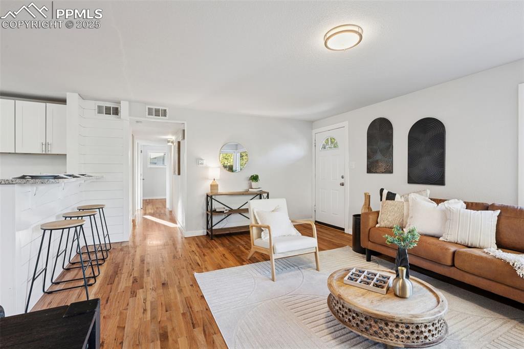 Image 12 of 20: Living area featuring light wood finished floors