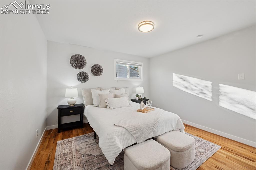 Image 18 of 20: Bedroom with baseboards and wood finished floors