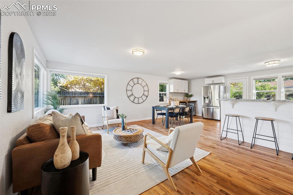 Image 8 of 20: Living area featuring light wood-style floors and baseboards